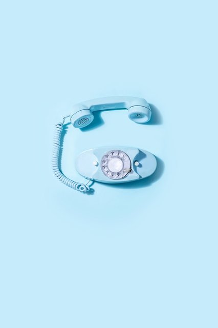 blue-vintage-rotary-telephone-laid-on-blue-background.jpg