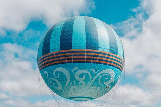 playful-patterned-sphere-hot-air-balloon-floats-in-blue-sky.jpg